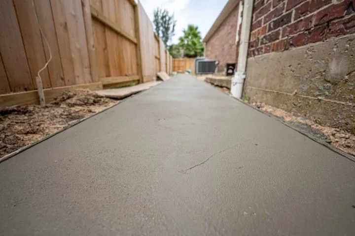 Smooth concrete walkway with decorative finish in a backyard